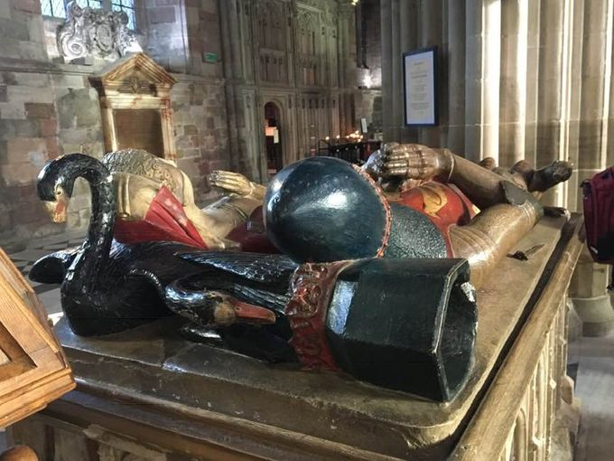 United in death, a Knight and his Lady, black swans serving, somewhat eccentrically, as their pillows. 